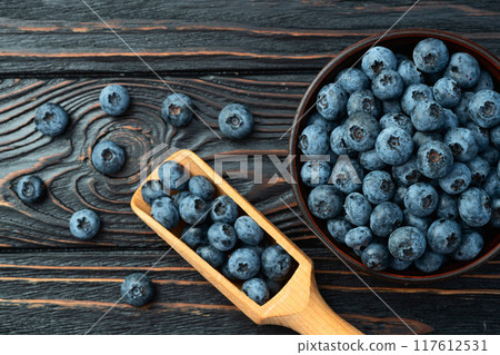 Blueberry photography in a bowl on rustic background 117612531