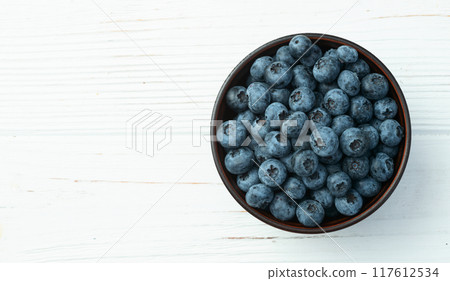 Blueberry photography in a bowl on rustic background 117612534