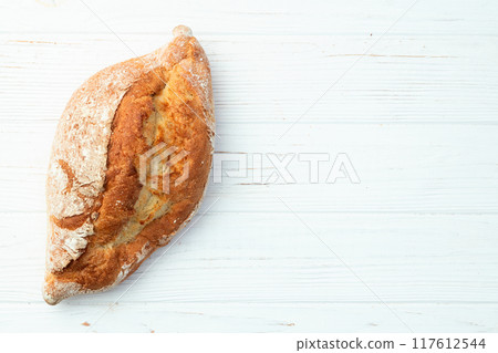 Loaf of  wheat hearth bread . Top view 117612544