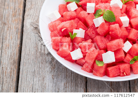 Summer watermelon salad with feta cheese and mint 117612547