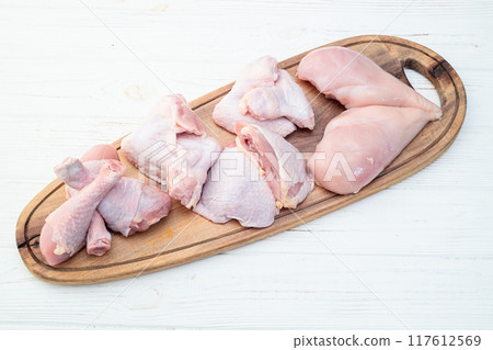 Raw mixed chicken meat parts  for cooking on rustic background 117612569