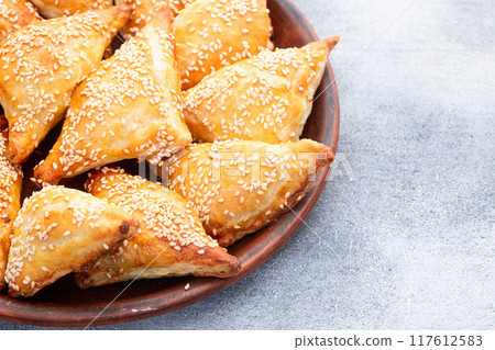 Homemade triangle puff pastry with meat on rustic background . Samosa 117612583