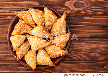 Homemade triangle puff pastry with meat on rustic background . Samosa 117612586