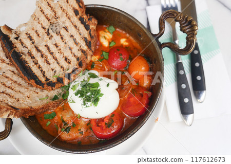 Enjoy a delicious Rustic Shakshuka with Grilled Bread in a modern and cozy setting 117612673
