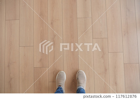 Explore the appeal of a stylish wooden floor paired perfectly with trendy sneakers 117612876