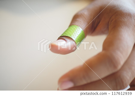 adhesive bandage on hand close up  117612939