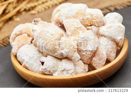 Powdered sugar-coated pastries filled with jam, perfect for sweet cravings and dessert lovers Powdered sugar-coated pastries filled with jam, perfect for sweet cravings and dessert lovers 117613229
