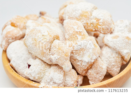 Powdered sugar-coated pastries filled with jam, perfect for sweet cravings and dessert lovers Powdered sugar-coated pastries filled with jam, perfect for sweet cravings and dessert lovers 117613235