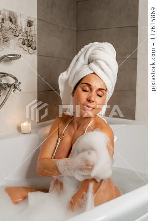 Pregnant Woman in Bath with Towel and Candles Pregnant Woman in Bath with Towel and Candles 117615869