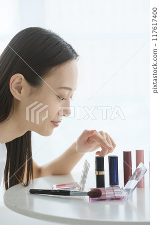 A woman choosing cosmetics A woman choosing cosmetics 117617400