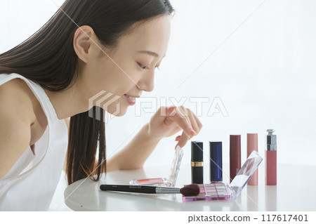 A woman choosing cosmetics A woman choosing cosmetics 117617401