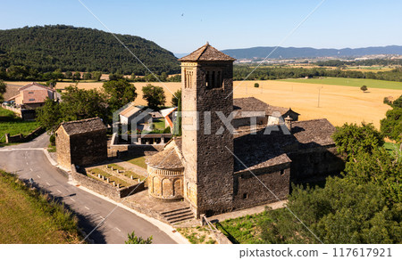 Aerial view of bell tower and apse of the Mozarab Pre-Romanesque or Romanesque Church of San Pedro de Larrede in the Serrablo Region. Spain 117617921