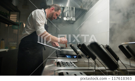 Chef Turning On The Stove Under The Pan 117618363