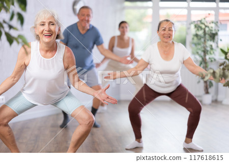 Group of people of different ages dancing in studio 117618615