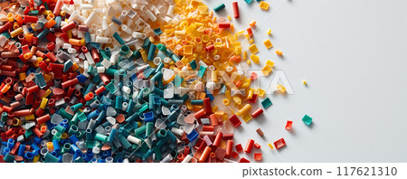 Colorful Microplastics on White Background Highlighting Environmental Hazard 117621310