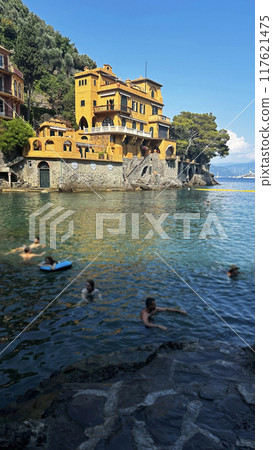 Brightly colored buildings in mountains of Portofino. Sea and coast of Liguria. Relaxation and enjoyment of summer. Brightly colored buildings in mountains of Portofino. Sea and coast of Liguria. Relaxation and enjoyment of summer. 117621475