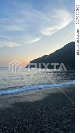 Soft pink and blue sunset over sea near mountain. Vertical background for design. Nature, sky with clouds. Soft pink and blue sunset over sea near mountain. Vertical background for design. Nature, sky with clouds. 117621562