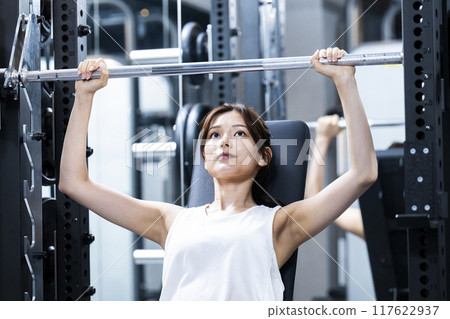 Young woman training in a sports gym Young woman training in a sports gym 117622937