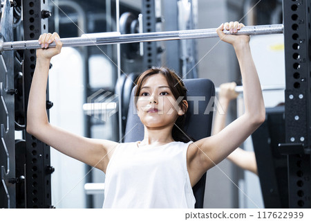 Young woman training in a sports gym Young woman training in a sports gym 117622939