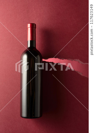 Bottle of red wine on a dark red background. Bottle of red wine on a dark red background. 117623149