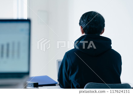 A man in casual style working on a computer A man in casual style working on a computer 117624151