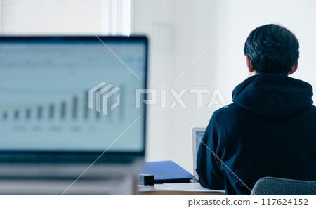 A man in casual style working on a computer A man in casual style working on a computer 117624152