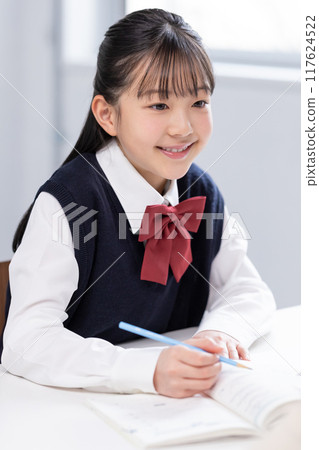 Female junior high school student studying with teacher at cram school Female junior high school student studying with teacher at cram school 117624522