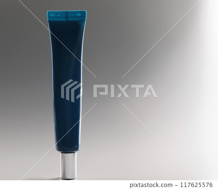 Blue tube with cream on a gray background, makeup Blue tube with cream on a gray background, makeup 117625576