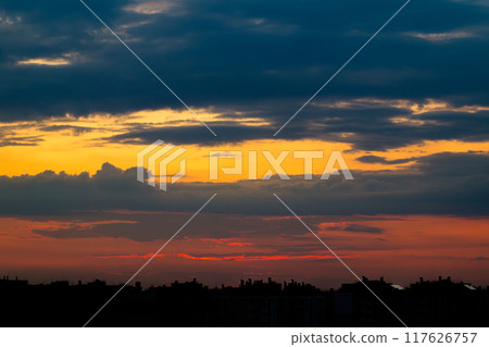 Sun Hid Behind the Silhouettes of Buildings at Sunset 117626757