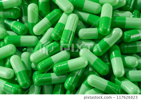 Foreground of the pills in dark green and pastel green to help them catch the light and shine. Often used as a model for pain relievers, antibiotics, and treatment drugs 117626823