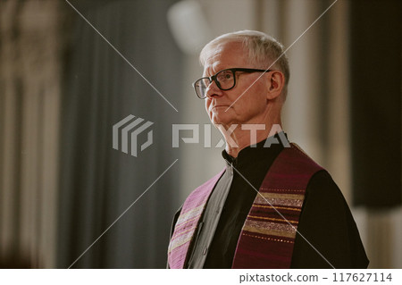 Senior pastor preparing to offer up prayer in church 117627114