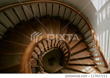 Top down shot of antique wooden spiral staircase in old church 117627212