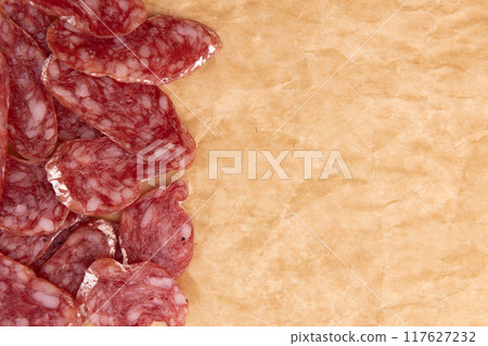slices of salami on parchment paper 117627232
