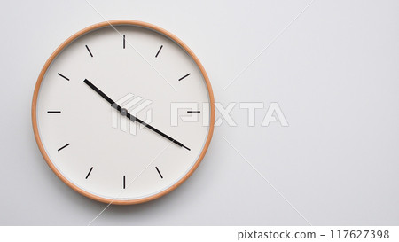 Minimalist wooden Wall Clock on White Wooden Surface with Space for Text. Time Set at 22.20/10.20 Minimalist wooden Wall Clock on White Wooden Surface with Space for Text. Time Set at 22.20/10.20 117627398