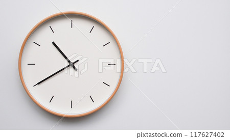 Minimalist wooden Wall Clock on White Wooden Surface with Space for Text. Time Set at 22.40/10.40 Minimalist wooden Wall Clock on White Wooden Surface with Space for Text. Time Set at 22.40/10.40 117627402