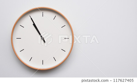 Minimalist wooden Wall Clock on White Wooden Surface with Space for Text. Time Set at 22.55/10.55 Minimalist wooden Wall Clock on White Wooden Surface with Space for Text. Time Set at 22.55/10.55 117627405