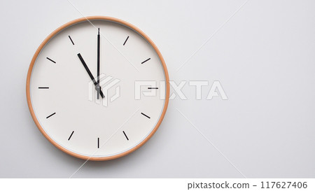 Minimalist wooden Wall Clock on White Wooden Surface with Space for Text. Time Set at 23.00/11.00 Minimalist wooden Wall Clock on White Wooden Surface with Space for Text. Time Set at 23.00/11.00 117627406