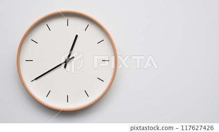 Minimalist wooden Wall Clock on White Wooden Surface with Space for Text. Time Set at 00.40/12.40 117627426