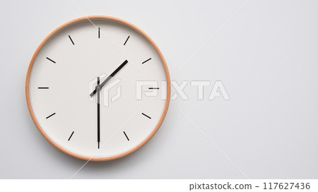 Minimalist wooden Wall Clock on White Wooden Surface with Space for Text. Time Set at 13.30/01.30 117627436
