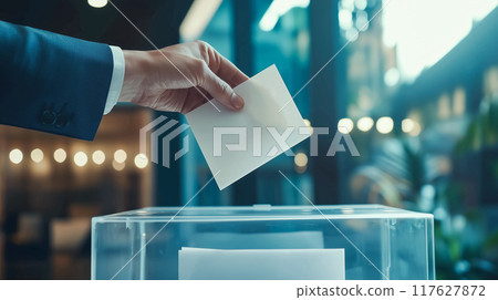 Voting scene with focus on hand holding ballot 117627872