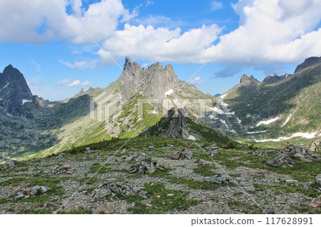 Summer mountain landscape with high sharp rocky peaks Summer mountain landscape with high sharp rocky peaks 117628991