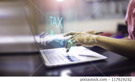 Businessman using laptop to fill in the income tax online return form for payment.business using computer filling personal income tax return to pay tax.Futuristic virtual screen interface technology. 117629282