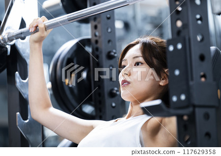 Young woman training in a sports gym Young woman training in a sports gym 117629358