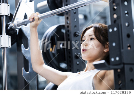 Young woman training in a sports gym Young woman training in a sports gym 117629359