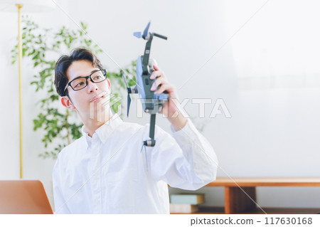 一名男子在家中檢查和維護無人機 一名男子在家中檢查和維護無人機 117630168