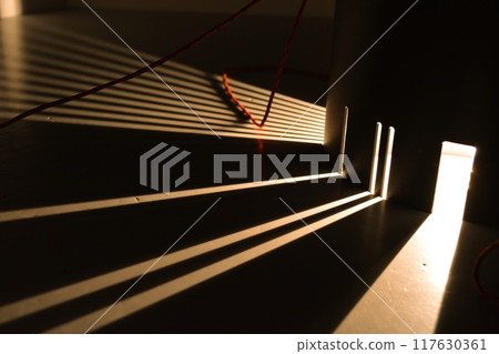 Rays of light are refracted on a black background. Background with a place for text in a stylish and modern concept for advertising phones, perfumes, appliances. Rays of light are refracted on a black background. Background with a place for text in a stylish and modern concept for advertising phones, perfumes, appliances. 117630361