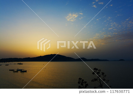 Sunrise from behind the mountains to the sea 117630771