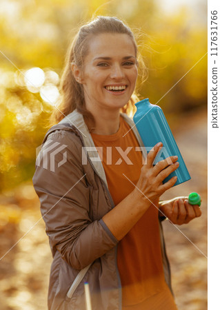 Portrait of smiling woman in fitness clothes in park Portrait of smiling woman in fitness clothes in park 117631766