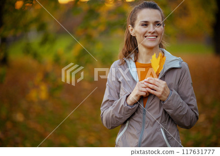 happy trendy woman in fitness clothes in park happy trendy woman in fitness clothes in park 117631777