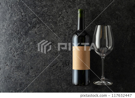 Bottle of red wine on a black stone background. Bottle of red wine on a black stone background. 117632447